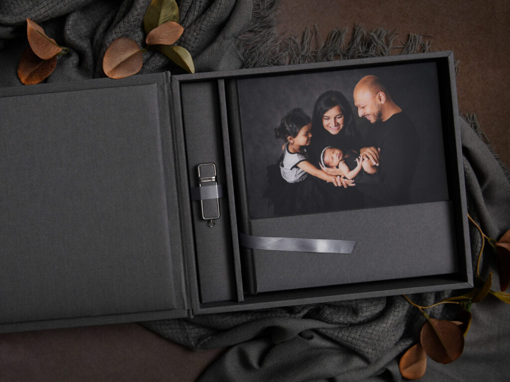 Acrylic cover newborn photography album presented in matching fabric keepsake box by Jamie Englert Photography, serving West Chester and the Main Line.