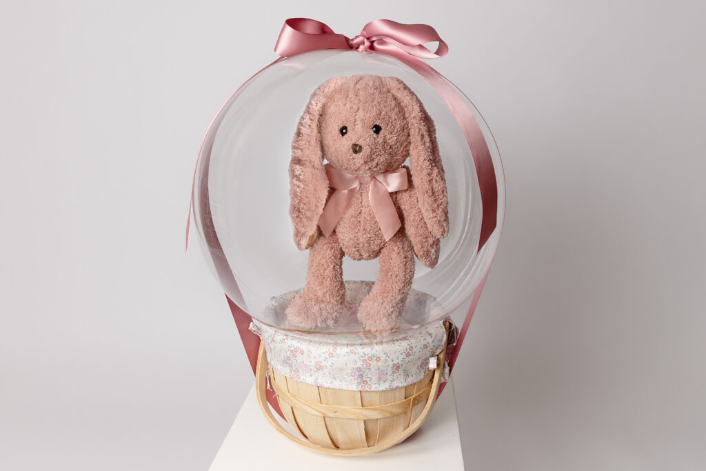 Personalized Baby’s First Easter balloon basket with plush bunny inside clear balloon gift – newborn Easter keepsake for families in Villanova, Wayne, and Glen Mills PA.