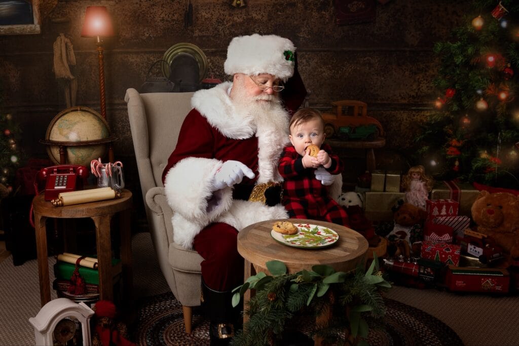 Baby enjoying cookies with Santa during a Christmas portrait session in Glen Mills, PA.
