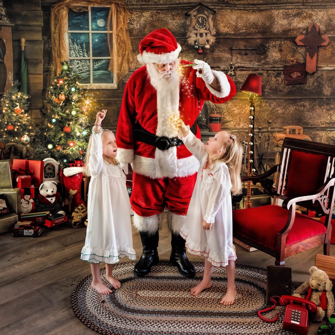 Santa creates a magical moment with two children during a Christmas photography experience near West Chester, PA.