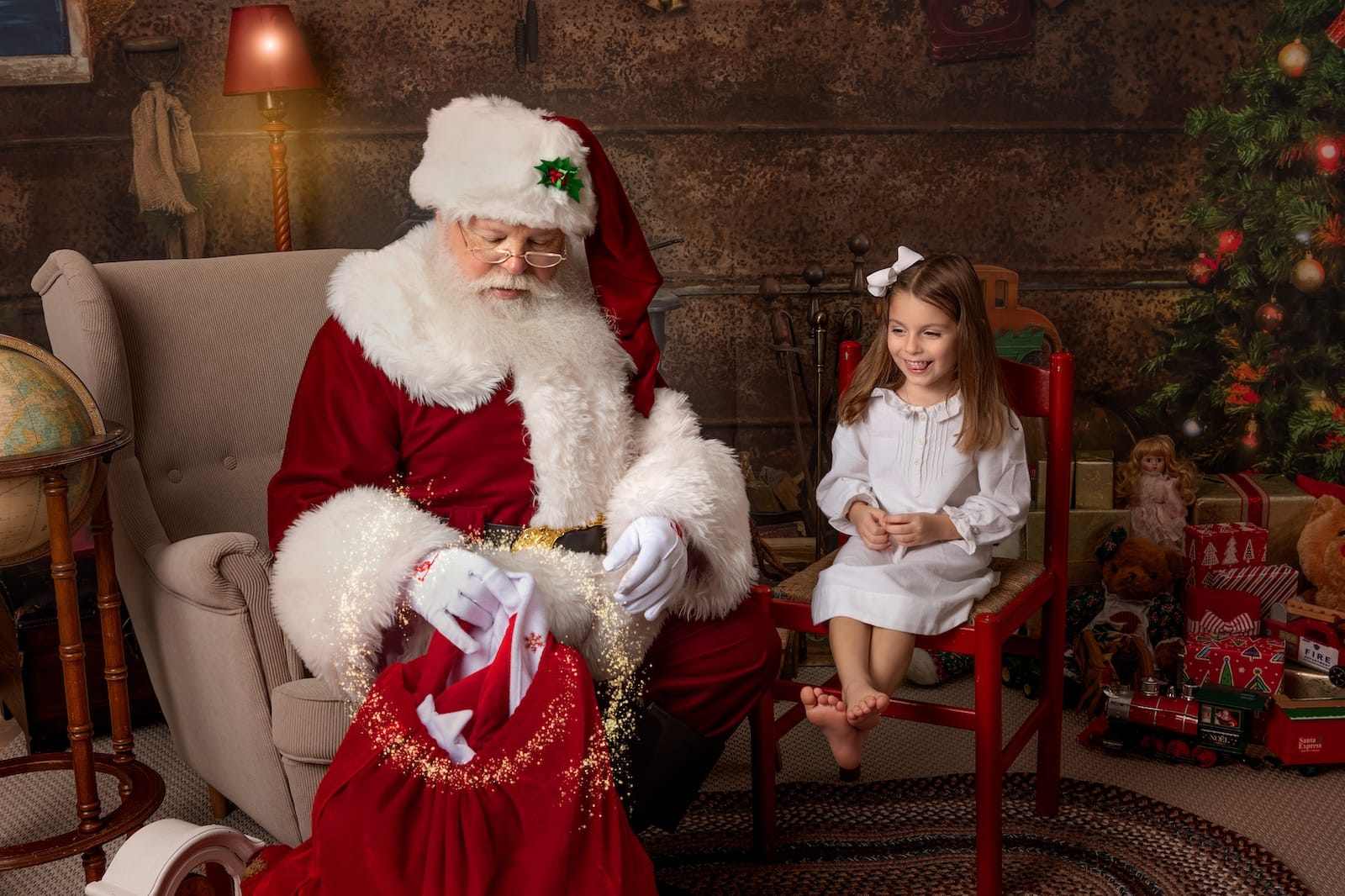 Young girl enjoying an interactive Santa portrait session at a Glen Mills, PA photography studio.