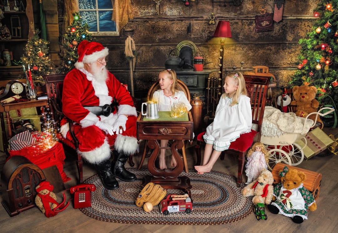 Two children enjoy cookies and conversation with Santa during an interactive Santa session near Haverford, PA.