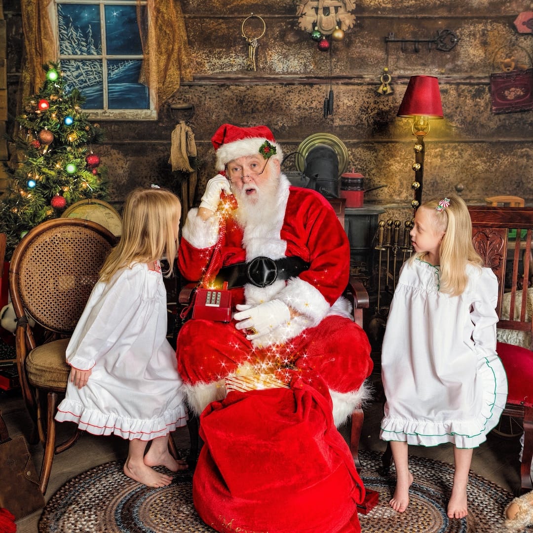 Santa shares a magical Christmas moment with two children during a Santa photography experience near the Philadelphia Main Line.